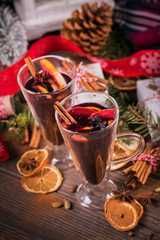 Mulled wine with fruits, cinnamon sticks, anise and decorations