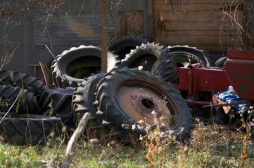 Fototapeta na wymiar Tractor Wheels Rust Weeds