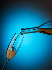 Champagne is poured into a glass from the bottle