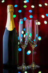 Two empty glasses for champagne and bottle in the New Year's bok