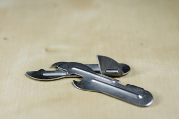 Simple metal plate opener on the countertop in the restaurant. A silver and shining bottle opener.