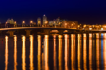 Obraz na płótnie Canvas Havana bridge in Kiev at night with colorful illumination and reflection in Dnieper river
