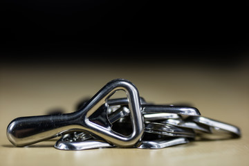 Simple metal plate opener on the countertop in the restaurant. A silver and shining bottle opener.