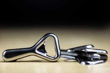 Simple metal plate opener on the countertop in the restaurant. A silver and shining bottle opener.