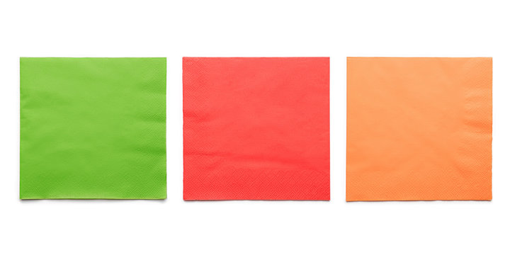 Three colored paper napkins on white