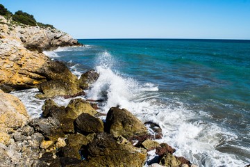Fototapeta na wymiar Water splash on rocky coastline, Spain
