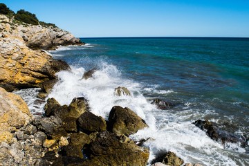 Fototapeta na wymiar Water splash on rocky coastline, Spain