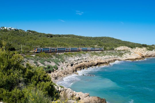 Fototapeta Train on the coastline, Spain