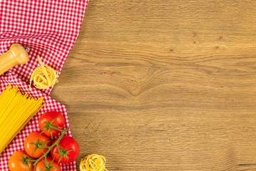 Italian food and raw ingredients on wooden background. Top view with space for your text.