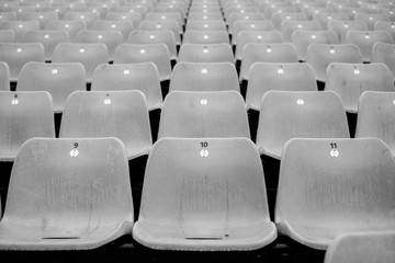 Fototapeta premium Empty sports stadium seats after a rain shower