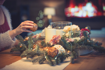 Woman decorating christmas table