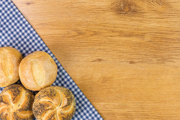 Fresh bread on wooden table background.