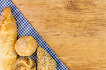 Fresh bread on wooden table background.