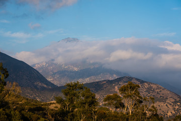 Clouds hang over mountains.