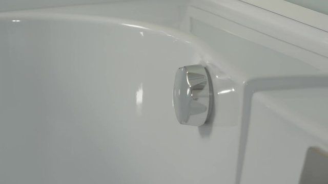 Hand turn on faucet shower cabin. Opening a water tap. Open valve shower