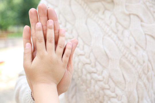 Child giving high five to grandmother, closeup