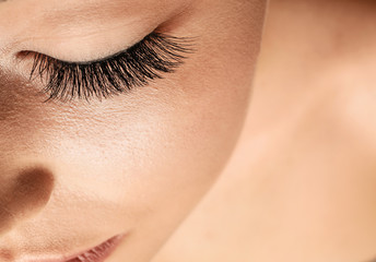 Beautiful young woman with eyelash extensions, closeup
