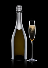 Bottle and glass of yellow champagne on black