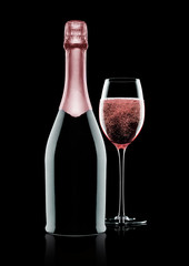 Bottle and glass of pink rose champagne on black