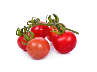 fresh tomatoes with green leaves isolated on white background