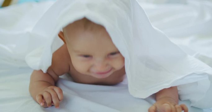 Cute happy little baby laughing and playing