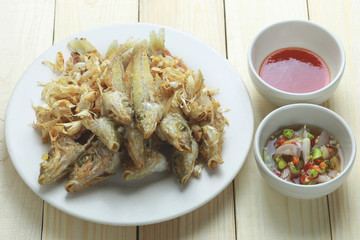 SILVER SILLAGO fish fried with garlic on dish.