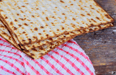Matzoh for jewish holiday Passover pesah on wooden background.