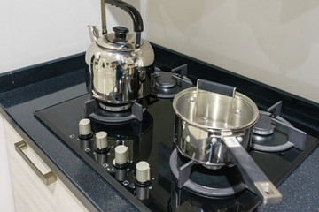 Metal Pot on induction hob in modern kitchen. modern kitchen pot cooking induction electrical stove...