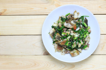 Fried fish with celery puff of Thai foods in white dish.
