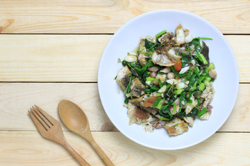 Fried fish with celery puff of Thai foods in white dish.