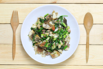 Fried fish with celery puff of Thai foods in white dish.