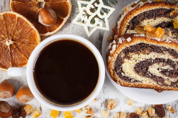 Poppy seeds cake, cup of black coffee and spruce branches, dessert for Christmas festive time