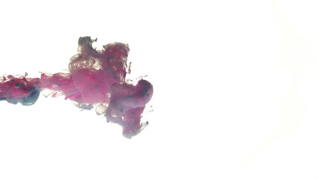 Color ink dropped in water on white background
