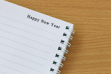 book on the table and the text of Happy new year.