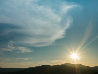 Fototapeta premium the beautiful blue sky with cloudy background and silhouette mountain with the sun