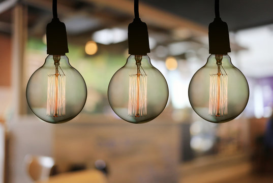 Vintage lamp or Modern Light bulb hang on ceiling in the restaurant.
