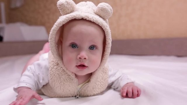 bear costume. 
 portrait of adorable blue-eyed 6 months old baby boy. Natural light 



