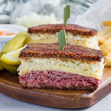 Classic reuben sandwich, served with dill pickle, potato chips, square format