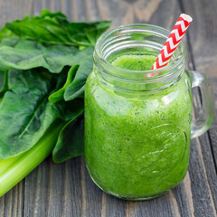 Green smoothie with celery, cucumber, spinach, apple and lemon, square