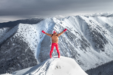 A man stands on top of a mountain