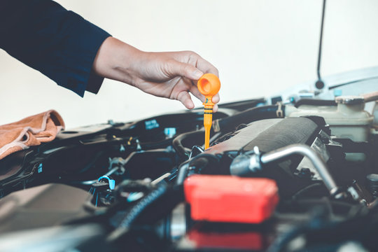 Car Engine oil mechanic working in auto repair service