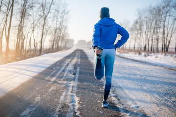 Runner stretching in winter Park. A healthy way of life.