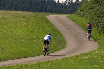 cyclists in a distance view on a summer sunny day © rudolfgeiger