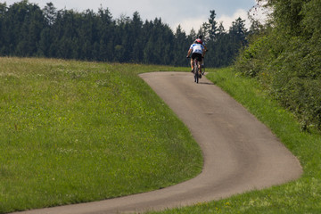cyclists in a distance view on a summer sunny day © rudolfgeiger