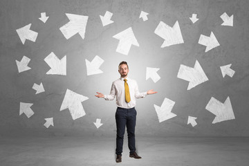 Businessman standing with arrows around