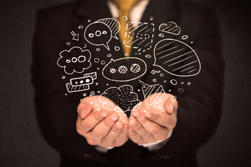 Businessman holding speech bubbles