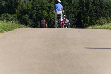 cyclists in a distance view on a summer sunny day © rudolfgeiger
