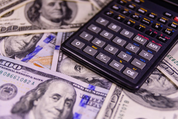 Modern calculator on a one hundred dollar bills