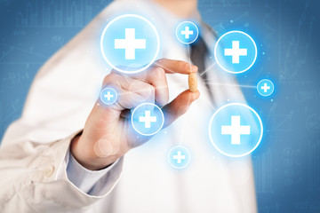 A doctor showing a pill with crosses