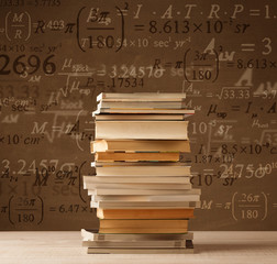 Books on vintage background with math formulas